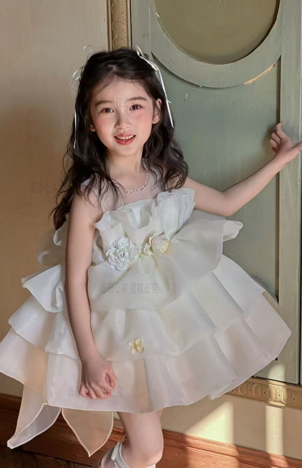 Ivory petal cloud dress with big bow at back and 3 flowers at waist