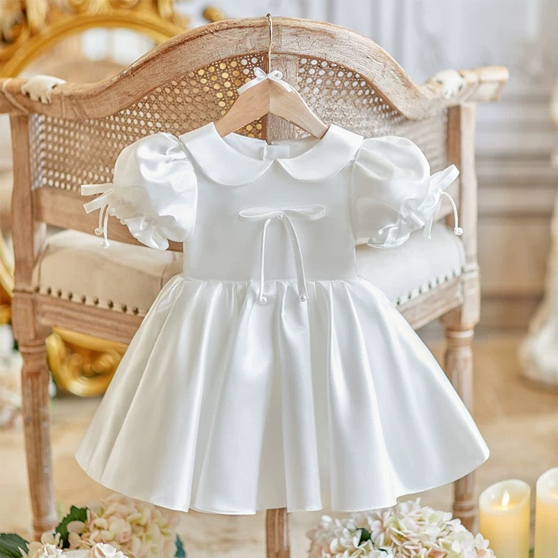 Elegant satin dress with cute bows and puffy sleeves and doll collar