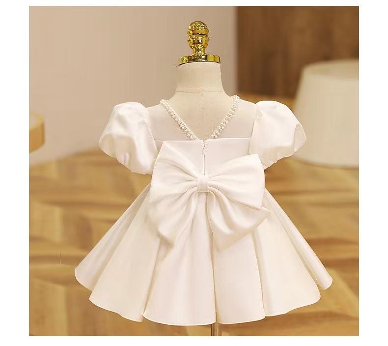 Elegant satin dress with piff sleeves and big removable bow at back