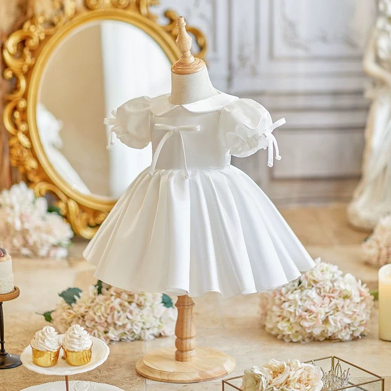 Elegant satin dress with cute bows and puffy sleeves and doll collar