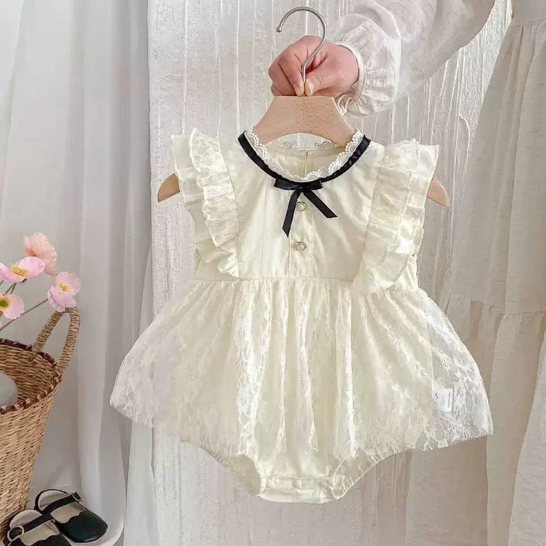 Beige baby sleeveless romper dress with black ribbon bow