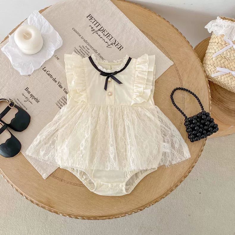 Beige baby sleeveless romper dress with black ribbon bow