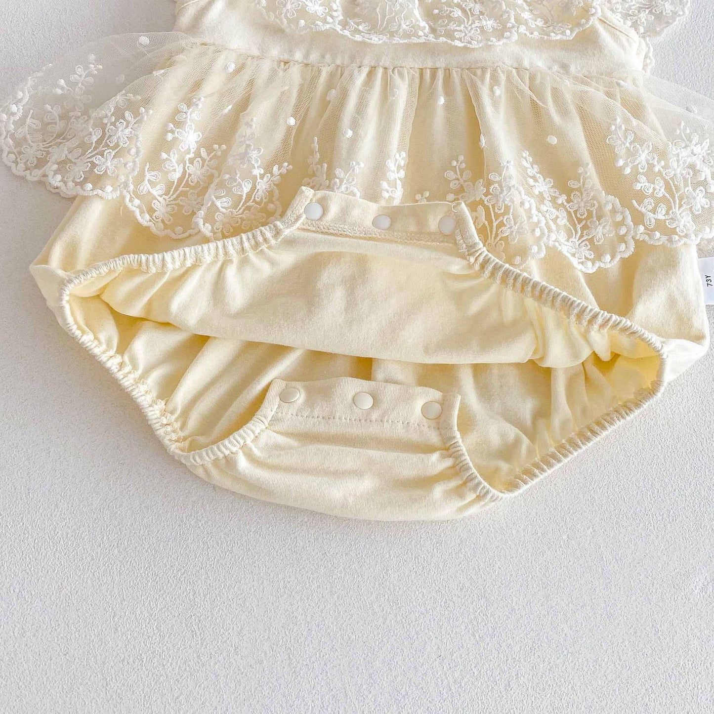 Beige baby romper dress with lace collar and bow knot
