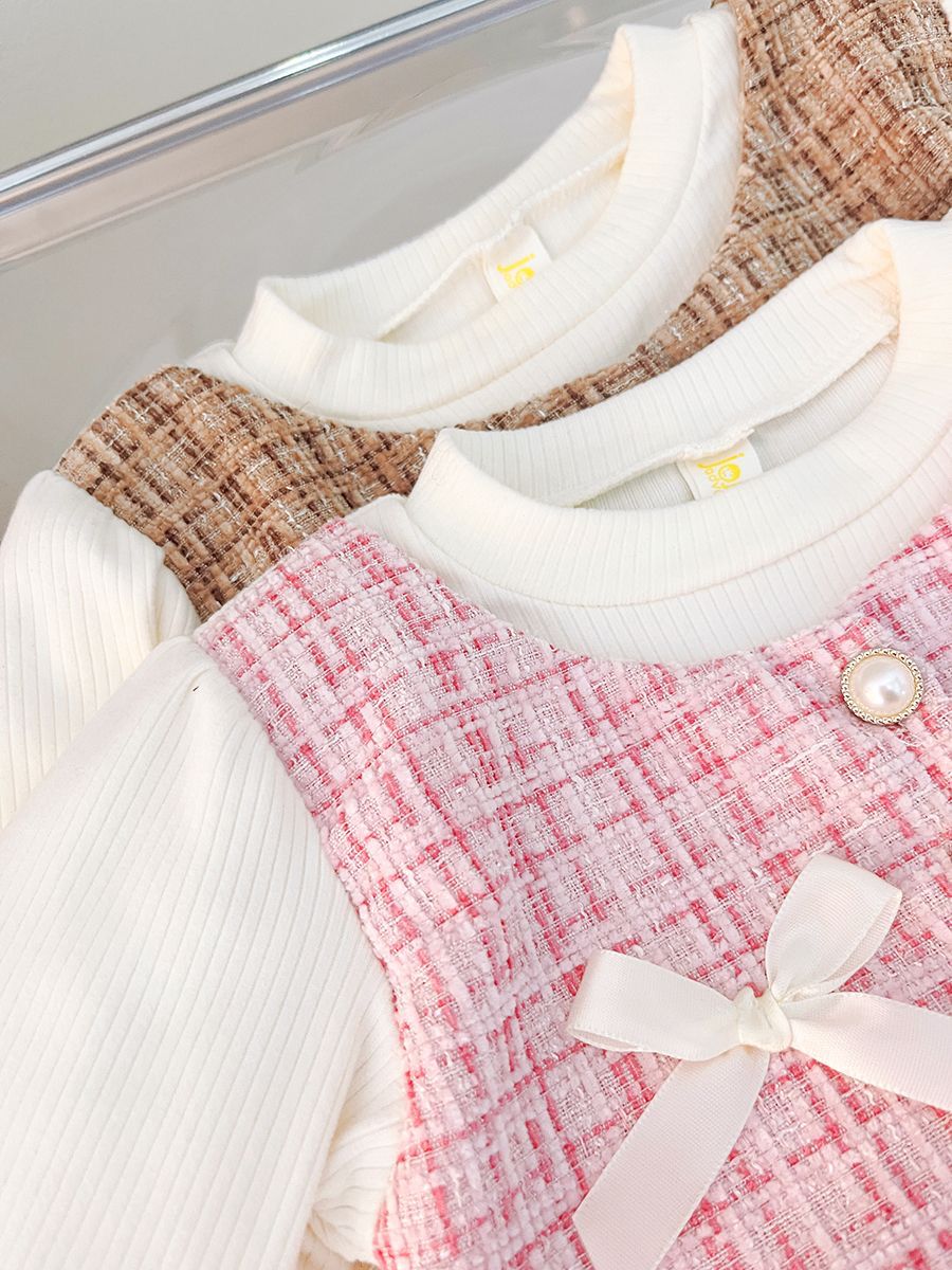 long sleeve dress with tulle skirt , 2 bows at chest .