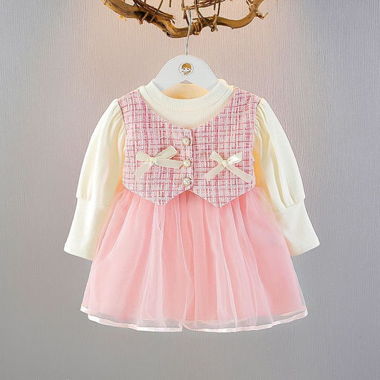 long sleeve dress with tulle skirt , 2 bows at chest .