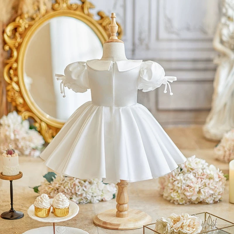Elegant satin dress with cute bows and puffy sleeves and doll collar
