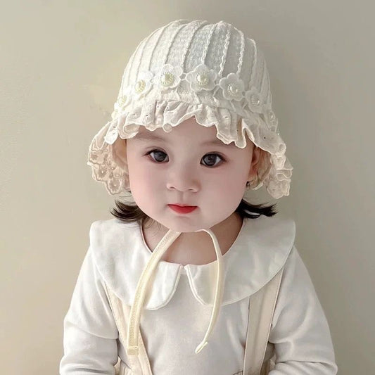 Cotton hat with flowers and pearls .