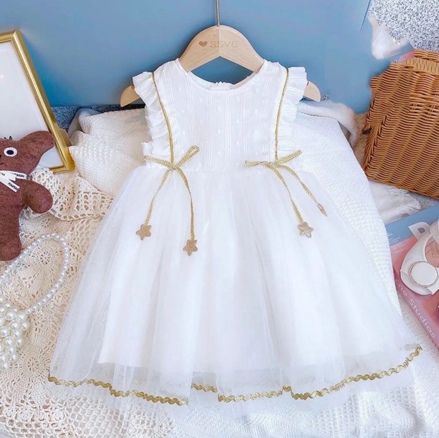 White princess dress with gold stars hanging